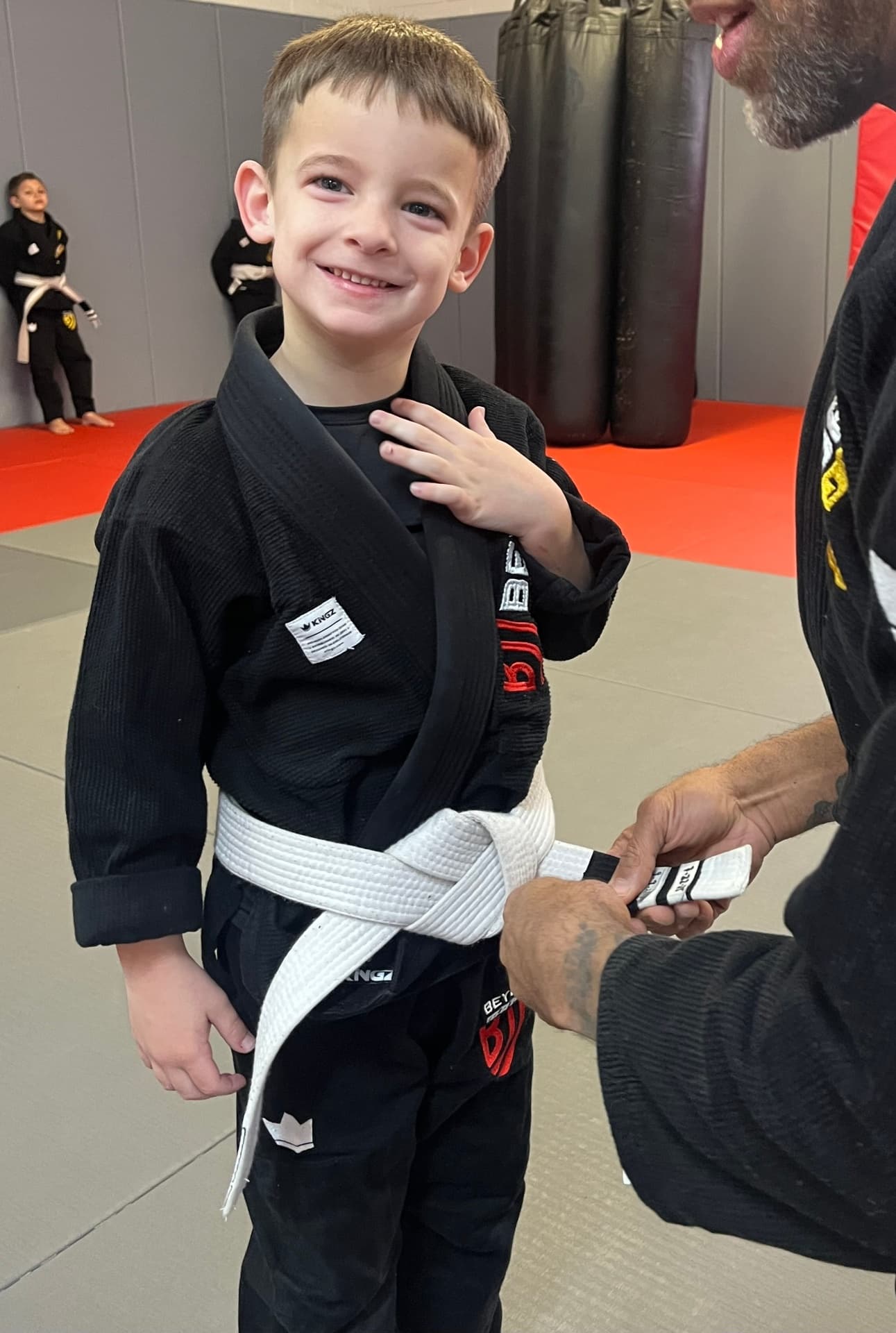 Young champion receiving first stripe